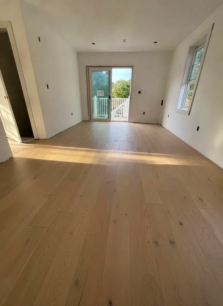 Finished white oak hardwood floor installed in a bright South Shore room